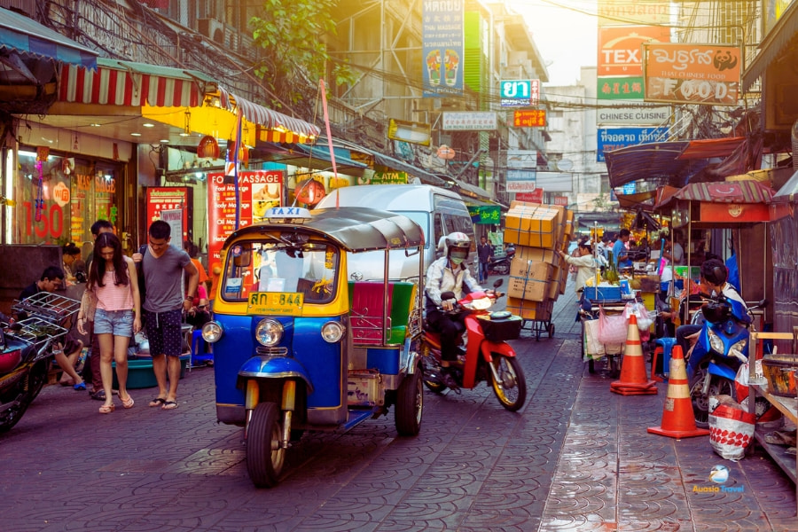 Colorful tuk tuk driving through busy Bangkok street market Thailand – Auasia Travel